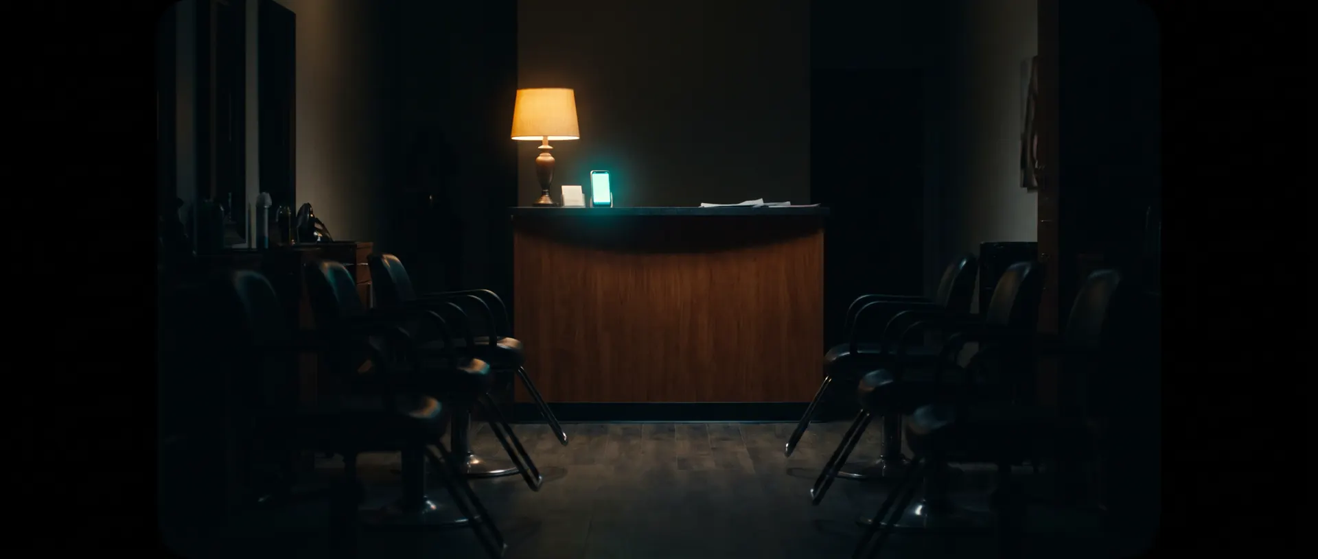 A salon after closing, chairs empty and lights low, the following day already booked